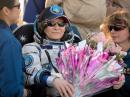 Peggy Whitson, KC5ZTD, received a bouquet upon her return to Earth. Two Russian nurses attend to her. [NASA photo]